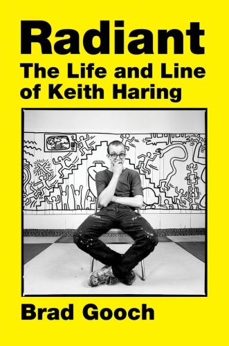 Book cover is yellow with a black and white photo in the center of a white person sitting in a chair